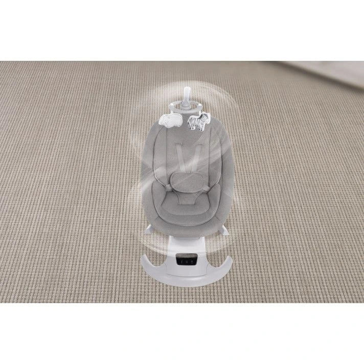 Baby swing with a baby doll on a textured surface